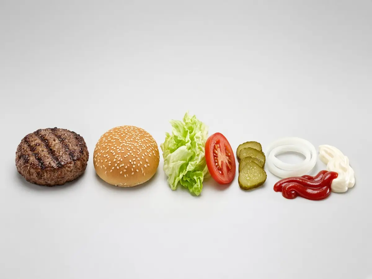 Original food-photo illustration of a grilled patty, sesame bun, lettuce, tomato, pickle, onion, ketchup, and mayonnaise for Burger King Whopper menu prices, not an official logo or product photo.
