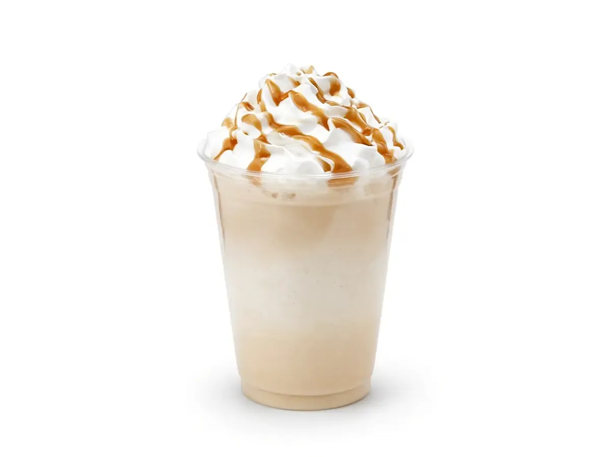 Original drink photograph of a pale latte with whipped cream and a caramel drizzle, with no logo.